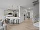Open kitchen with a large island, bar seating, pendant lights, and hardwood floors at 5581 Soft Shell Dr, Lancaster, SC 29720
