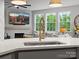 Bright kitchen with sink, stainless faucet, white countertops, and large windows overlooking the backyard at 5581 Soft Shell Dr, Lancaster, SC 29720