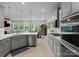 Well-lit kitchen with stainless appliances, granite counters, and seamless view into the living room at 5581 Soft Shell Dr, Lancaster, SC 29720