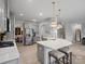 Open kitchen features an island with white marble countertop and stainless steel appliances at 5581 Soft Shell Dr, Lancaster, SC 29720