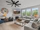 Inviting living room with a fireplace, large windows, comfortable seating, and a ceiling fan at 5581 Soft Shell Dr, Lancaster, SC 29720