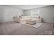 Spacious living room featuring a large sectional sofa and ottoman at 5581 Soft Shell Dr, Lancaster, SC 29720
