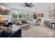 Spacious open living room and kitchen with modern decor, large windows, and comfortable seating at 5581 Soft Shell Dr, Lancaster, SC 29720