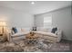 Bright living room with a large sectional sofa, patterned rug, and round coffee table at 5581 Soft Shell Dr, Lancaster, SC 29720