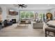 Open-concept living room featuring a fireplace, large windows, and a dining area in the background at 5581 Soft Shell Dr, Lancaster, SC 29720