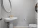 Bright powder room features a pedestal sink with a decorative mirror at 5581 Soft Shell Dr, Lancaster, SC 29720
