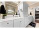 Bathroom with double vanity, mirrors, storage, and granite countertops at 6010 Albiza Dr, Harrisburg, NC 28075