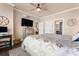 Comfortable bedroom with ceiling fan, decorative furnishings, and hardwood floors at 6010 Albiza Dr, Harrisburg, NC 28075