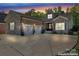 Beautiful brick home featuring a two-car garage and well-maintained landscaping at dusk at 6010 Albiza Dr, Harrisburg, NC 28075