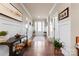 Welcoming foyer with hardwood floors, wainscoting, and a bright entry door at 6010 Albiza Dr, Harrisburg, NC 28075