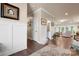 Elegant foyer with hardwood floors, wainscoting, and views into the living room at 6010 Albiza Dr, Harrisburg, NC 28075