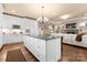 Spacious kitchen with a large center island, white cabinetry, and stainless steel appliances at 6010 Albiza Dr, Harrisburg, NC 28075