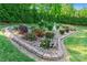 Beautifully landscaped garden with a variety of colorful flowers, shrubs, and lush greenery at 6010 Albiza Dr, Harrisburg, NC 28075