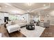 Open-concept living room with hardwood floors, a modern kitchen, and ample seating at 6010 Albiza Dr, Harrisburg, NC 28075