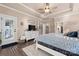 Spacious main bedroom offers tray ceiling, dresser, windows, access to the bathroom and closet at 6010 Albiza Dr, Harrisburg, NC 28075