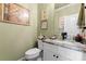 Charming powder room featuring decorative artwork and attractive fixtures at 6010 Albiza Dr, Harrisburg, NC 28075
