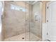 Modern shower features glass doors, tiled walls, bench, showerhead, and window at 6010 Albiza Dr, Harrisburg, NC 28075