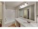 Bathroom with tub-shower, vanity and mirror showcasing modern design at 6020 Gray Gate Ln # I, Charlotte, NC 28210