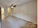 Open bedroom featuring carpet floors, neutral walls, and ceiling fan at 6020 Gray Gate Ln # I, Charlotte, NC 28210