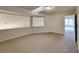 Cozy room with neutral carpet, skylight, and partial wall overlooking another room at 6020 Gray Gate Ln # I, Charlotte, NC 28210