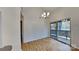 Bright dining area featuring wood floors, modern lighting, and a sliding glass door to outdoor deck at 6020 Gray Gate Ln # I, Charlotte, NC 28210