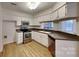 Well-lit kitchen with stainless steel appliances, light countertops, and white cabinets at 6020 Gray Gate Ln # I, Charlotte, NC 28210