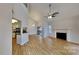 Spacious living area featuring hardwood floors, a fireplace, and an open view of the kitchen at 6020 Gray Gate Ln # I, Charlotte, NC 28210
