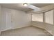 Cozy room with neutral carpet, a skylight, and a white door at 6020 Gray Gate Ln # I, Charlotte, NC 28210