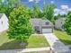 Aerial view featuring a lovely home with mature trees, green lawn, and long driveway at 6021 Piscataway Ct, Rock Hill, SC 29732