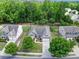 An aerial view shows the home nestled between mature trees and other neighborhood homes at 6021 Piscataway Ct, Rock Hill, SC 29732