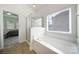 Bathroom boasts a soaking tub, a glass-enclosed shower, and a bright window at 6021 Piscataway Ct, Rock Hill, SC 29732