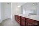 Bright bathroom features a double sink vanity, large mirror, and walk-in shower at 6021 Piscataway Ct, Rock Hill, SC 29732