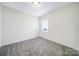 This bedroom has neutral paint, carpeting, and one window for natural light at 6021 Piscataway Ct, Rock Hill, SC 29732