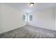This bedroom has neutral paint, carpeting, and two windows for natural light at 6021 Piscataway Ct, Rock Hill, SC 29732