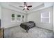 Large bedroom features three windows, a ceiling fan, and neutral carpeting at 6021 Piscataway Ct, Rock Hill, SC 29732