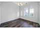 Formal dining room features a modern chandelier, hardwood flooring, and lots of natural light from the large windows at 6021 Piscataway Ct, Rock Hill, SC 29732