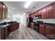 Modern kitchen featuring stainless steel appliances, dark countertops, and hardwood floors at 6021 Piscataway Ct, Rock Hill, SC 29732