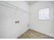 Bright laundry room includes tile flooring, window, and wire shelving at 6021 Piscataway Ct, Rock Hill, SC 29732