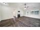 Spacious living room with hardwood floors, a ceiling fan, fireplace, and abundant natural light at 6021 Piscataway Ct, Rock Hill, SC 29732