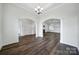 Open-concept living area with hardwood flooring, white trim, and seamless transitions to other rooms via arched doorways at 6021 Piscataway Ct, Rock Hill, SC 29732