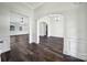Bright living area featuring new hardwood flooring, white walls, and arched doorways with elegant trim at 6021 Piscataway Ct, Rock Hill, SC 29732
