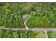Secluded house on large wooded lot features a long driveway and is surrounded by lush mature trees at 6171 Willow Farm Dr, Denver, NC 28037