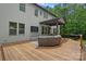 Spacious back porch features outdoor seating, a grill, and a view of the lush backyard, great for entertaining at 6171 Willow Farm Dr, Denver, NC 28037