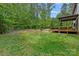 The lush backyard features a spacious lawn and mature trees providing a serene and private outdoor oasis at 6171 Willow Farm Dr, Denver, NC 28037