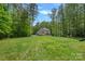 Expansive backyard featuring well-maintained lawn and mature trees, providing ample space for recreation and relaxation at 6171 Willow Farm Dr, Denver, NC 28037