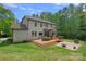 Large backyard with a deck, a grill and a firepit offers ample space for relaxation and outdoor entertaining at 6171 Willow Farm Dr, Denver, NC 28037