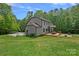Large backyard featuring an outdoor deck area and mature trees, offering an ideal setting for relaxation and enjoyment at 6171 Willow Farm Dr, Denver, NC 28037