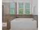 A modern bathroom featuring a soaking tub and a glass-enclosed shower at 6171 Willow Farm Dr, Denver, NC 28037