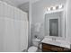 Traditional bathroom features a single vanity, white shower curtain, and neutral paint at 6171 Willow Farm Dr, Denver, NC 28037