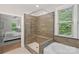 Modern bathroom features a glass enclosed shower with tiled bench and a separate soaking tub at 6171 Willow Farm Dr, Denver, NC 28037